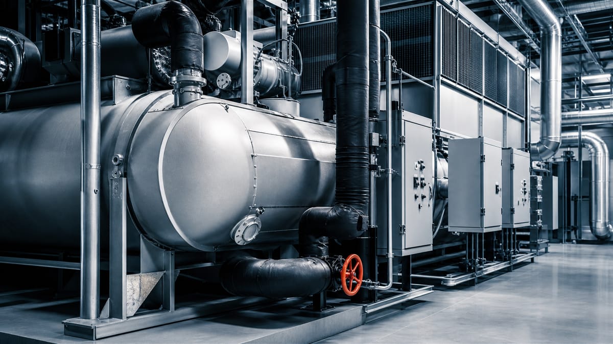 Industrial chillers and air-handling units inside a data-centre cooling plant.