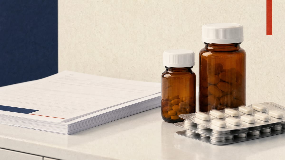 Amber pharmacy bottles and blister packs of oral medication on a clinical counter, representing specialty-pharmacy distribution of a newly approved drug.
