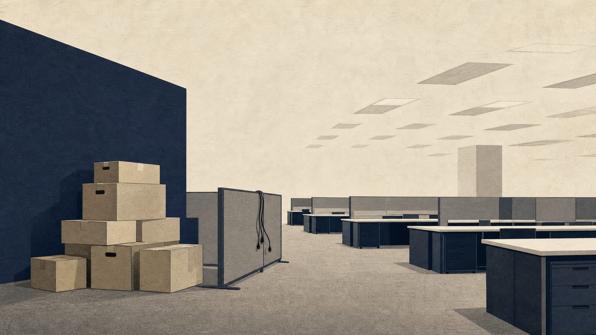 An emptied office floor with stacked moving boxes and unplugged cubicles, illustrating a company vacating leased office space.