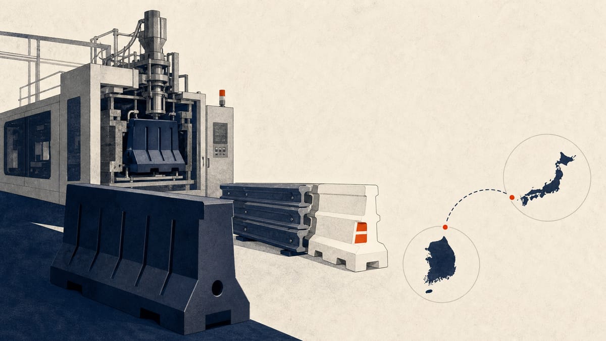 Moulded plastic road-safety barriers stacked beside a moulding machine in a factory, with a simple diagram linking two production sites.