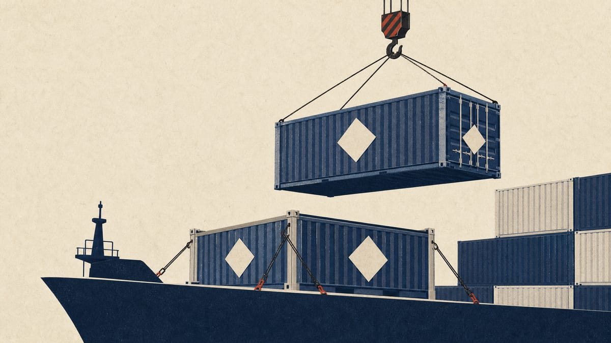 An open-top shipping container on a ship deck with blank hazard placards on its sides as a crane lowers another container.